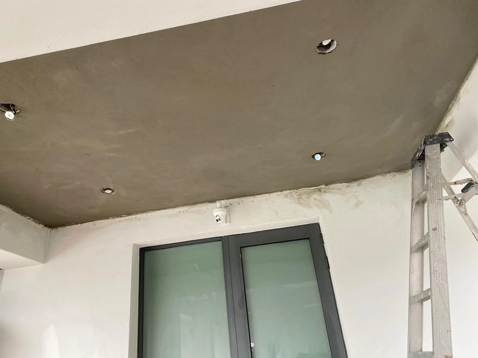 Resurfaced ceiling with openings for light fixtures