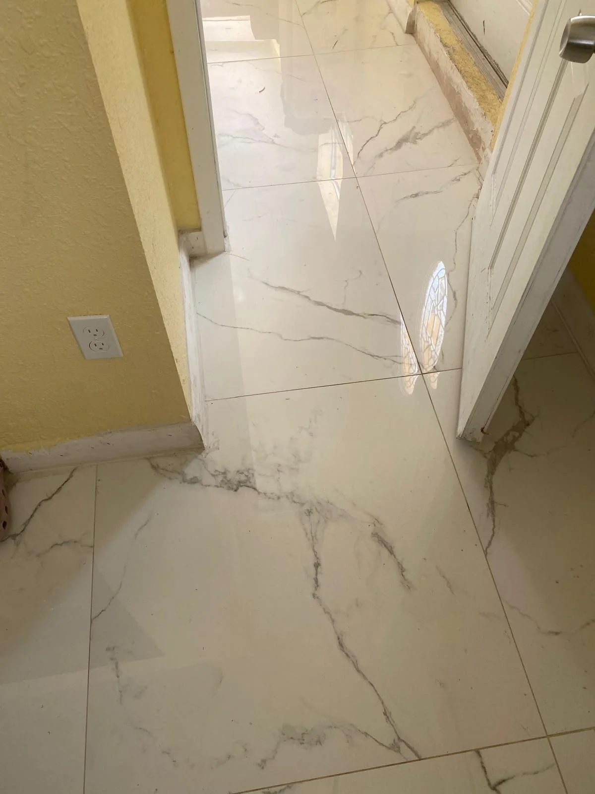Marble-look floor tile continuing through an interior doorway