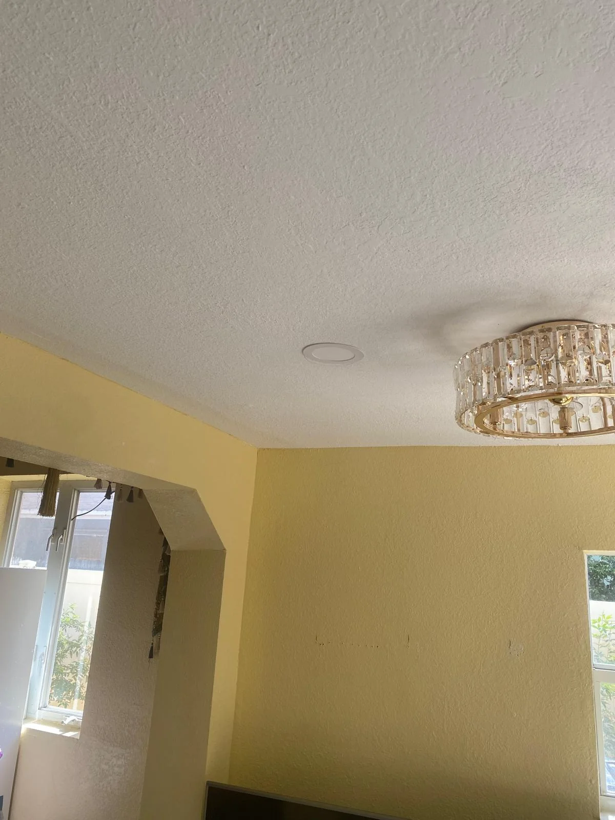 White ceiling and yellow walls with fixtures during interior work